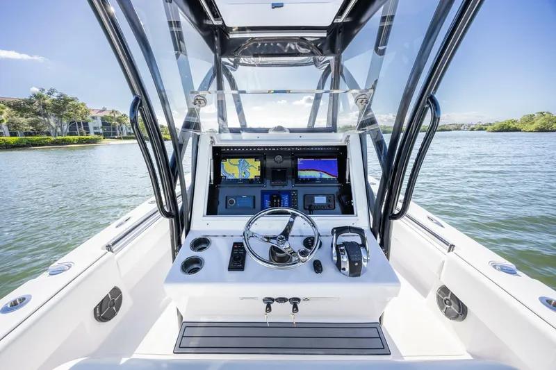Slide: The Image of 2019 SeaHunter 28 Floridian boat dashboard with navigation screens on a sunny day. - 13
