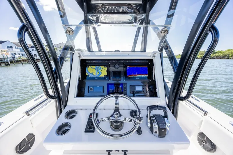 Slide: The Image of Cockpit view of 2019 SeaHunter 28 Floridian boat with navigation screens and controls. - 14