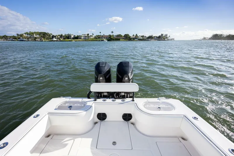 Slide: The Image of 2019 SeaHunter 28 Floridian boat on water, featuring dual engines and scenic coastal view. - 16