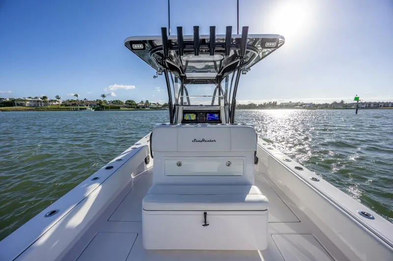Slide: The Image of 2019 SeaHunter 28 Floridian boat on sunny water, showcasing sleek design and open deck. - 17