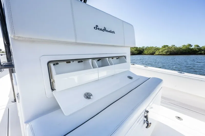 Slide: The Image of 2019 SeaHunter 28 Floridian boat interior with storage compartment, on calm water. - 18
