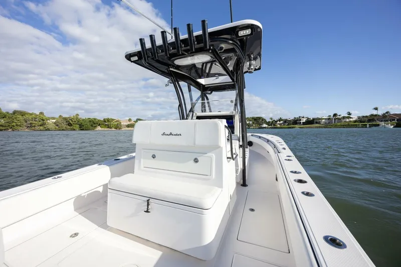 Slide: The Image of 2019 SeaHunter 28 Floridian boat on calm water, featuring sleek design and spacious deck. - 19
