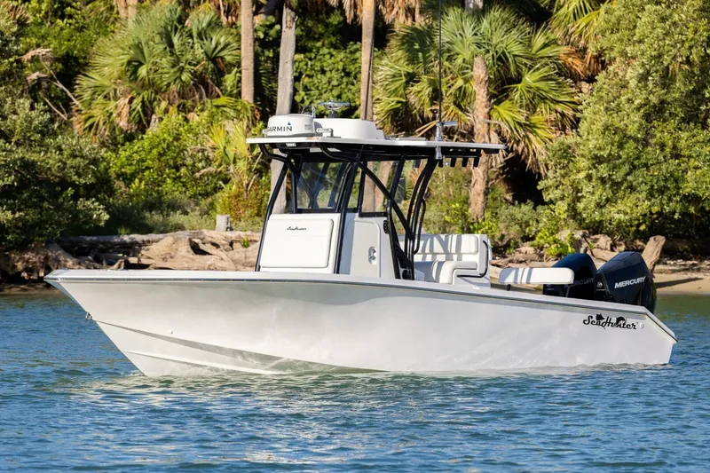 Slide: The Image of 2019 SeaHunter 28 Floridian boat cruising on a scenic waterway with lush greenery. - 3