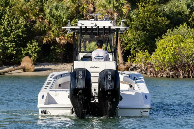 Slide: The Image of 2019 SeaHunter 28 Floridian boat with dual engines navigating through water. - 7