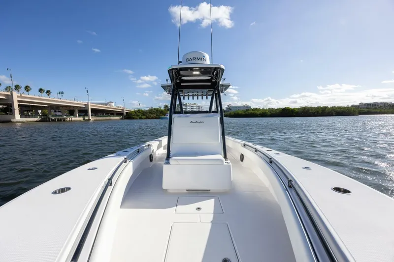 Slide: The Image of 2019 SeaHunter 28 Floridian boat on calm water under clear blue sky. - 8