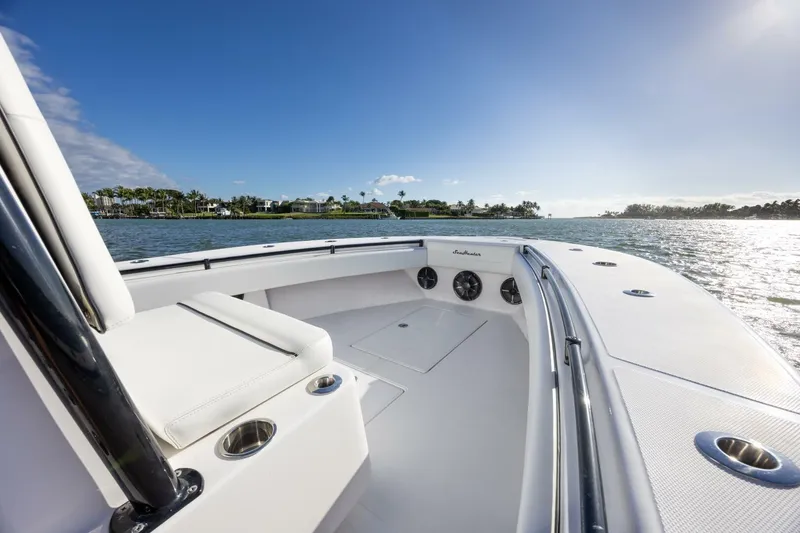 Slide: The Image of 2019 SeaHunter 28 Floridian boat on calm water, sunny day, spacious deck. - 9