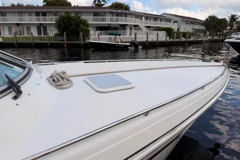 Slide: The Image of 2002 Formula 330 Sun Sport boat docked near waterfront homes. - 15