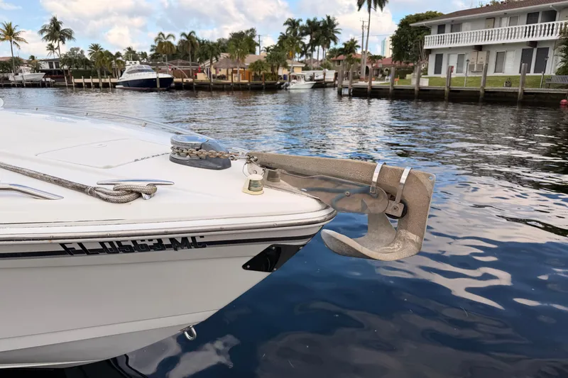 Slide: The Image of 2002 Formula 330 Sun Sport boat anchored in a scenic waterfront location. - 17