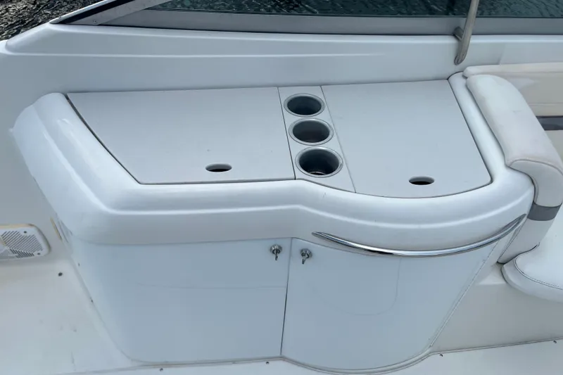 Slide: The Image of 2002 Formula 330 Sun Sport boat interior with cup holders and seating area. - 26