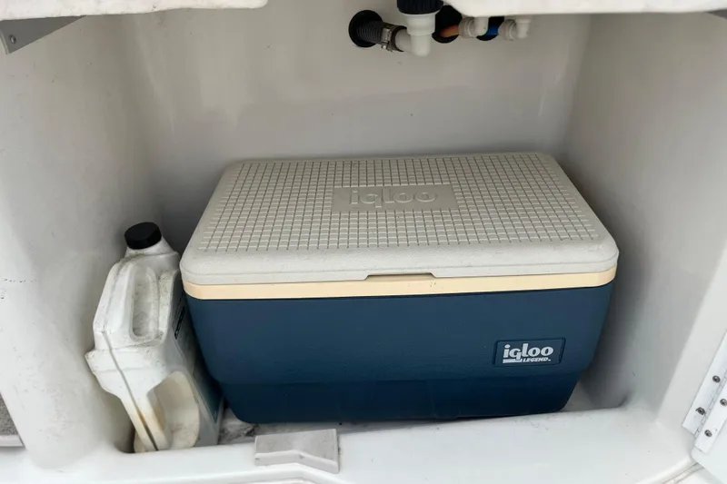 Slide: The Image of Cooler and container stored in a 2002 Formula 330 Sun Sport boat compartment. - 28