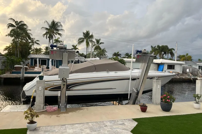 Slide: The Image of 2002 Formula 330 Sun Sport boat docked near tropical waterfront homes. - 3
