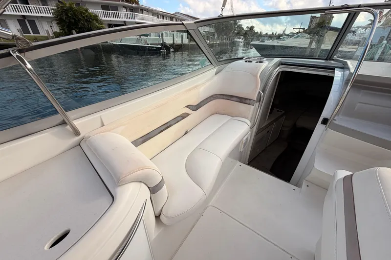 Slide: The Image of 2002 Formula 330 Sun Sport boat interior with white seating and waterfront view. - 31