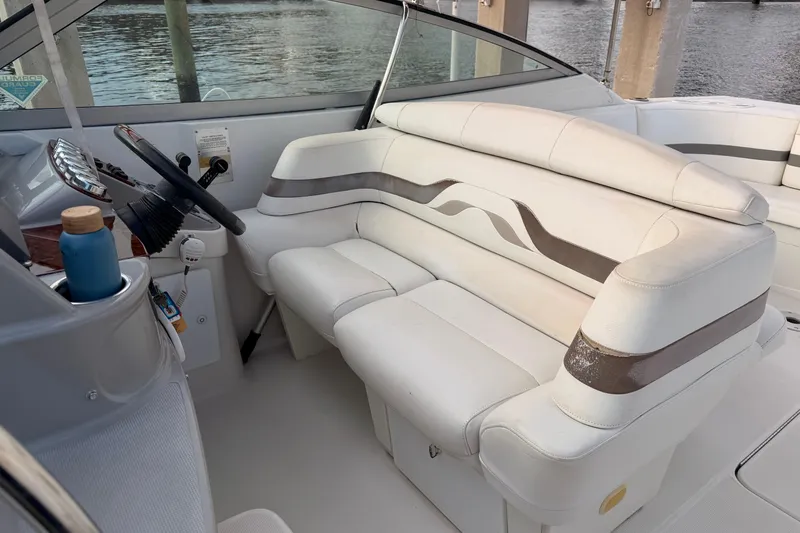 Slide: The Image of 2002 Formula 330 Sun Sport boat interior with white seating and steering wheel. - 32