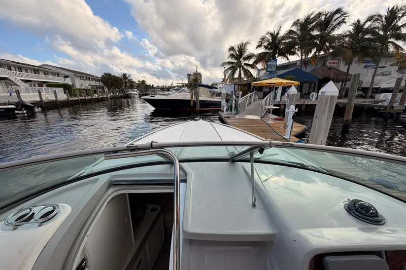Slide: The Image of 2002 Formula 330 Sun Sport boat docked near palm trees and waterfront buildings. - 33