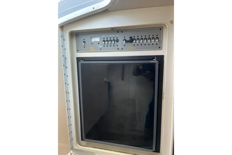 Slide: The Image of Control panel and refrigerator in a 2002 Formula 330 Sun Sport boat. - 49