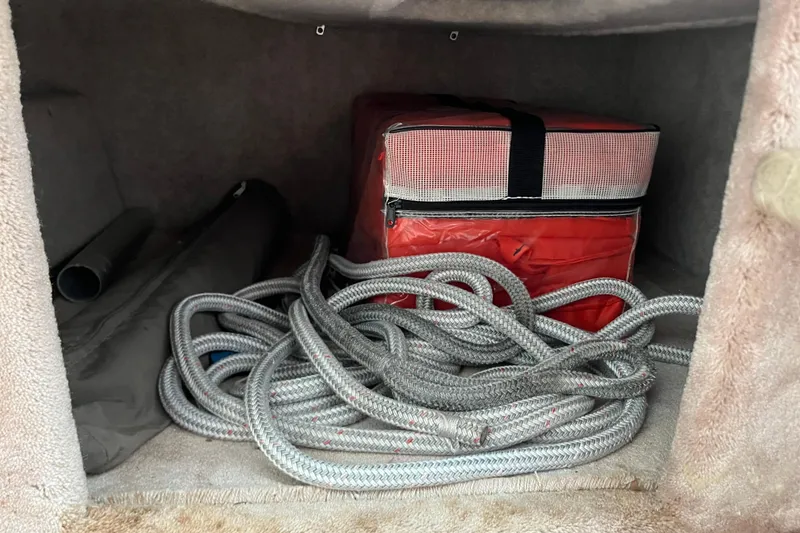 Slide: The Image of Storage compartment in a 2002 Formula 330 Sun Sport with rope and red bag. - 54