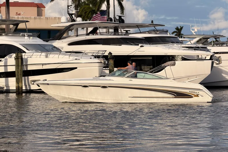 Slide: The Image of 2002 Formula 330 Sun Sport boat docked near luxury yachts. - 65