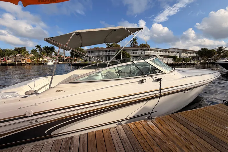 Slide: The Image of 2002 Formula 330 Sun Sport boat docked by waterfront homes under a blue sky. - 8