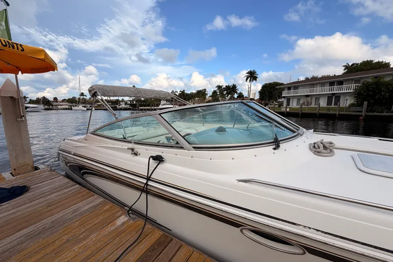 Slide: The Image of 2002 Formula 330 Sun Sport boat docked by waterfront homes under a blue sky. - 9