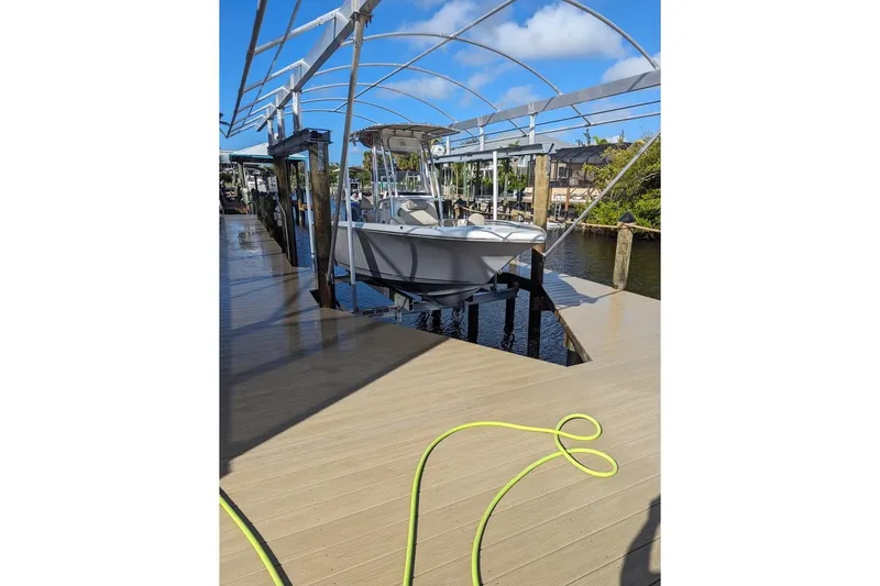 Slide: The Image of 2024 Key West 203 FS boat docked under canopy on a sunny day. - 8