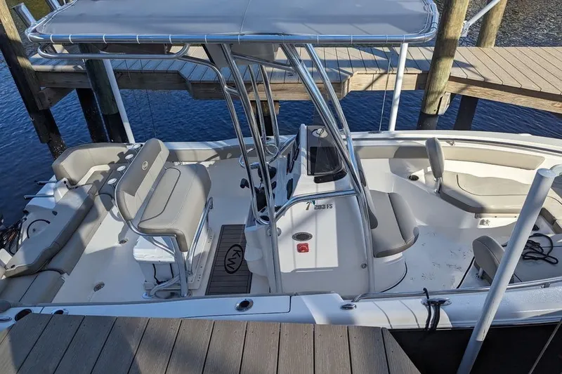 Slide: The Image of 2024 Key West 203 FS boat docked, featuring spacious seating and sleek design. - 9