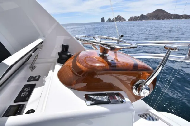 Slide: The Image of 2017 Viking 80 Sky Bridge yacht helm with ocean view and distant rocky islands. - 103
