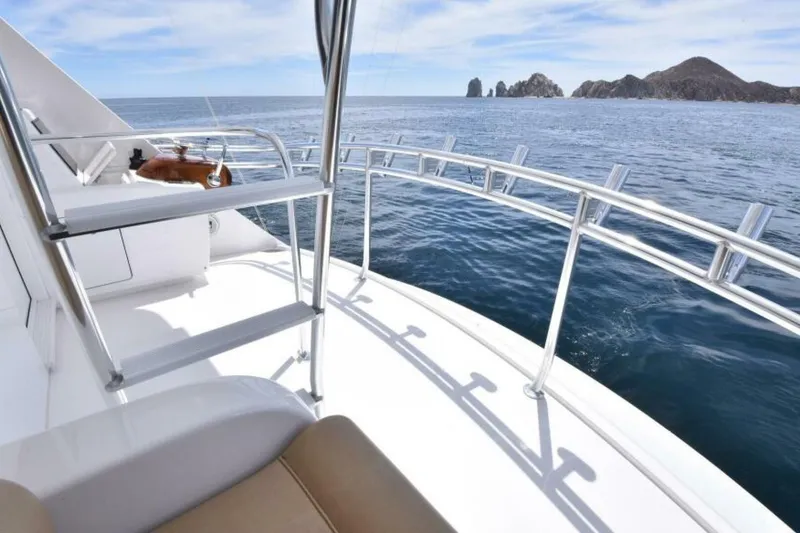 Slide: The Image of 2017 Viking 80 Sky Bridge yacht with ocean view and distant rocky islands. - 104