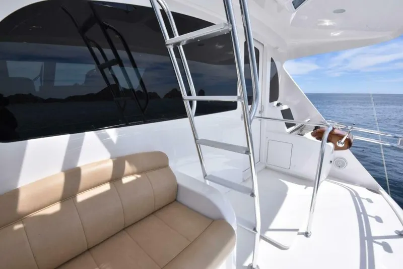 Slide: The Image of 2017 Viking 80 Sky Bridge yacht deck with seating and ocean view. - 105