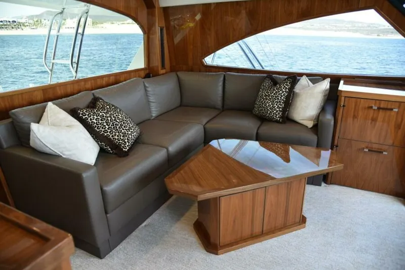 Slide: The Image of Luxurious interior of 2017 Viking 80 Sky Bridge yacht with leather sofa and wooden accents. - 11