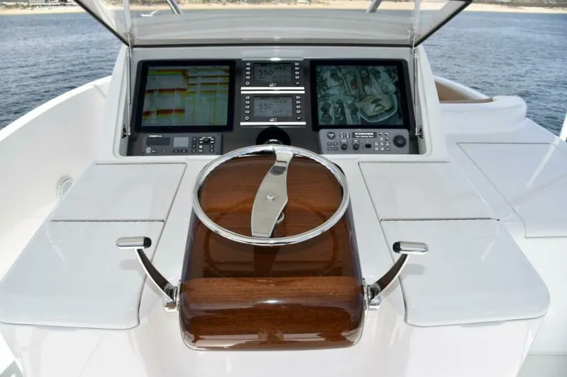 Slide: The Image of Steering console of 2017 Viking 80 Sky Bridge yacht with navigation screens. - 110