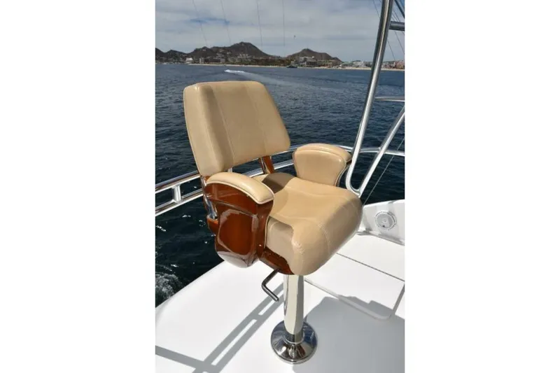Slide: The Image of Captain's chair on 2017 Viking 80 Sky Bridge yacht, overlooking ocean and distant coastline. - 111