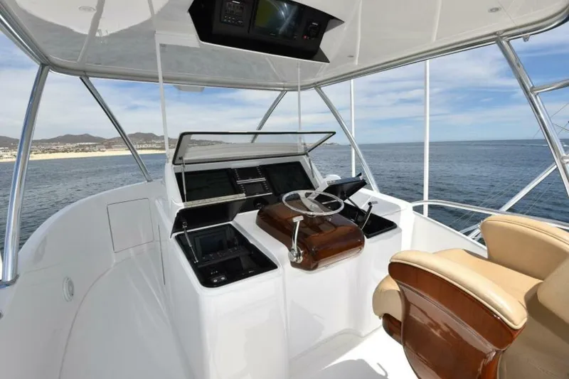 Slide: The Image of Helm of 2017 Viking 80 Sky Bridge yacht with ocean view and luxury seating. - 112