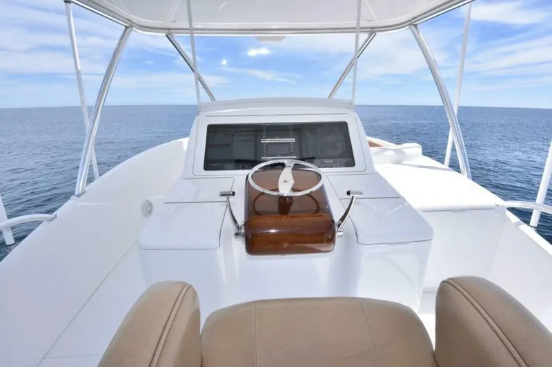 Slide: The Image of 2017 Viking 80 Sky Bridge yacht helm with ocean view and modern controls. - 114