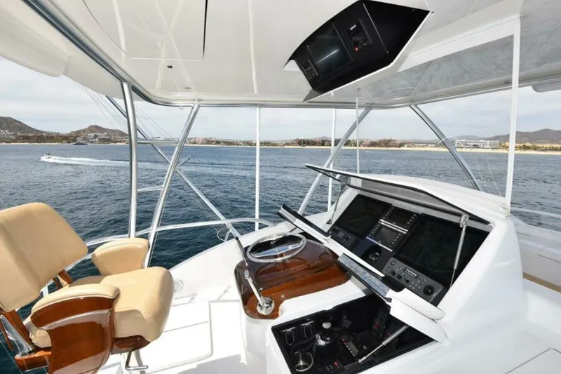 Slide: The Image of 2017 Viking 80 Sky Bridge yacht helm with ocean view and navigation equipment. - 116