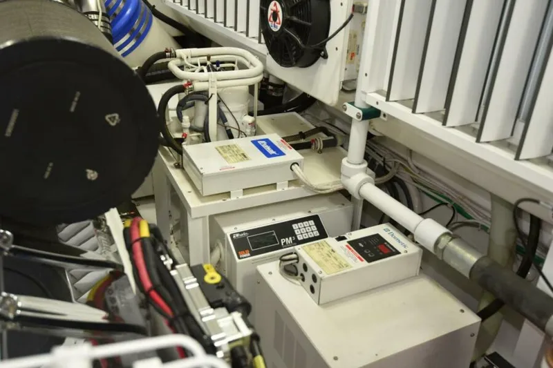 Slide: The Image of Engine room of 2017 Viking 80 Sky Bridge yacht, showcasing mechanical components and wiring. - 119