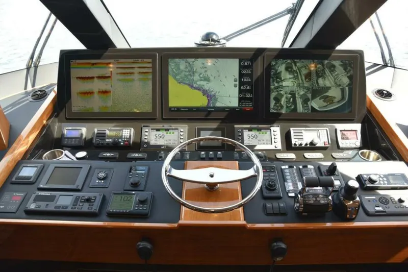 Slide: The Image of Helm of 2017 Viking 80 Sky Bridge yacht with advanced navigation displays and controls. - 12