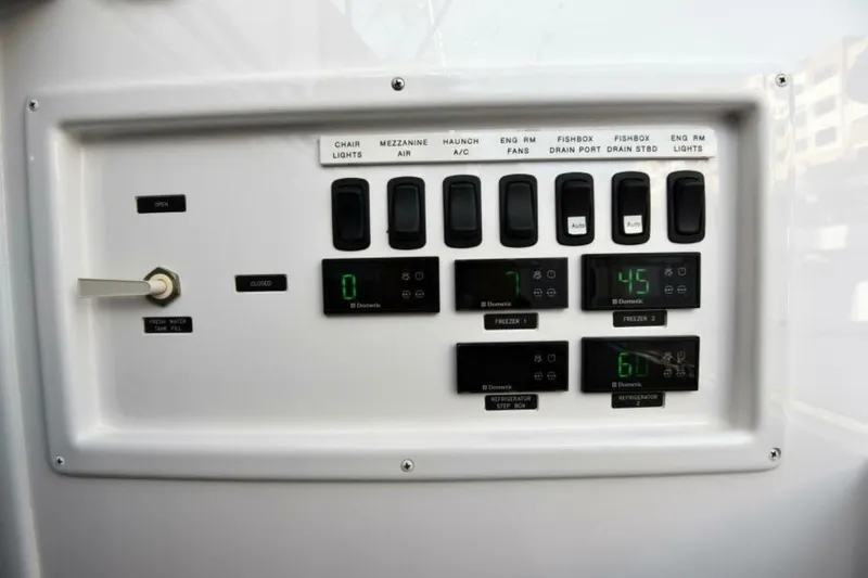 Slide: The Image of Control panel of a 2017 Viking 80 Sky Bridge yacht with switches and digital displays. - 120