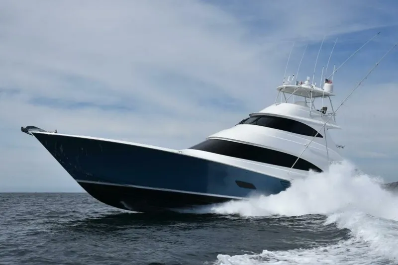 Slide: The Image of 2017 Viking 80 Sky Bridge yacht cruising on open water, creating waves. - 133