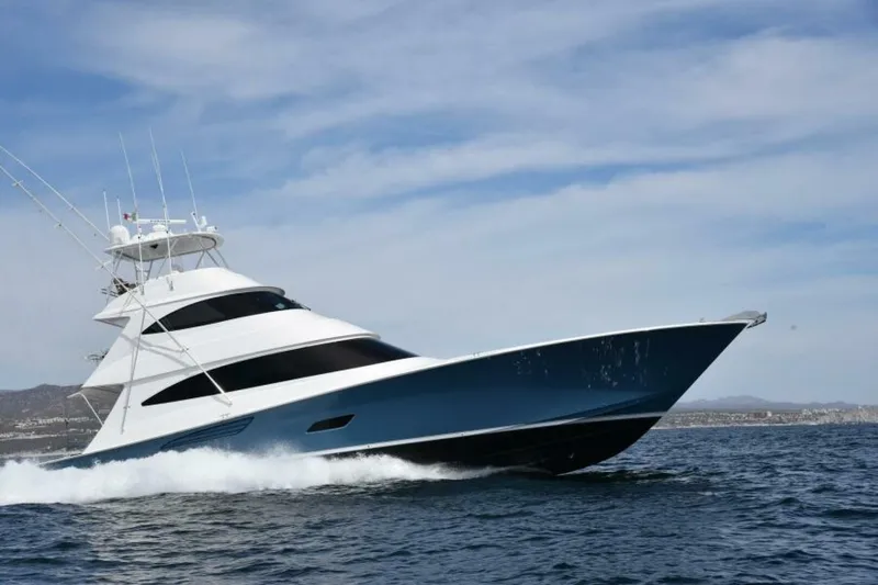 Slide: The Image of 2017 Viking 80 Sky Bridge yacht cruising on open water under a clear sky. - 134