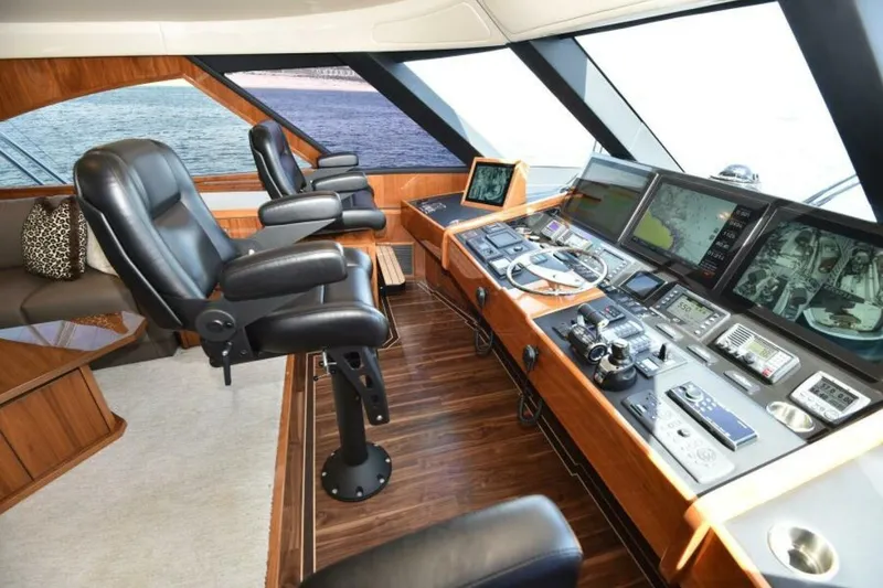 Slide: The Image of Luxurious helm of 2017 Viking 80 Sky Bridge yacht with advanced navigation controls. - 17