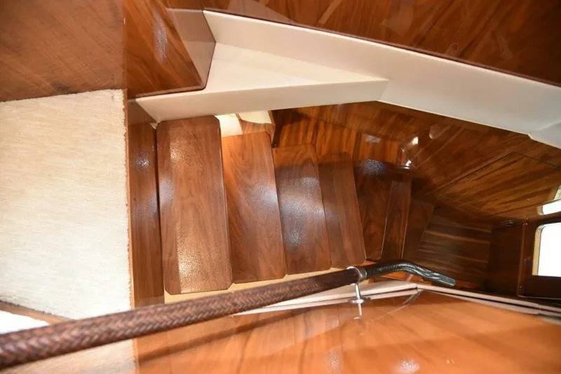 Slide: The Image of Wooden staircase inside 2017 Viking 80 Sky Bridge yacht, featuring polished finish and elegant design. - 20