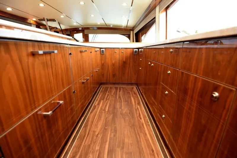 Slide: The Image of Luxurious wooden interior of a 2017 Viking 80 Sky Bridge yacht kitchen. - 21