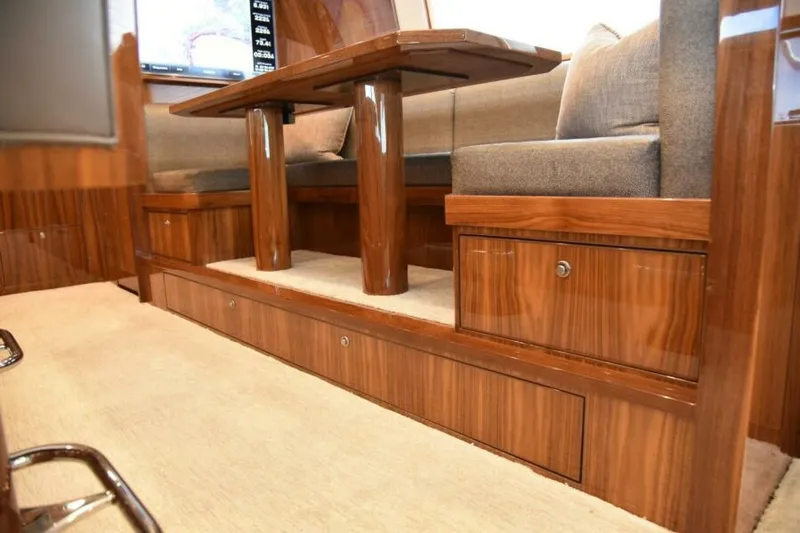 Slide: The Image of Luxurious interior of 2017 Viking 80 Sky Bridge yacht with wooden finish and cushioned seating. - 23