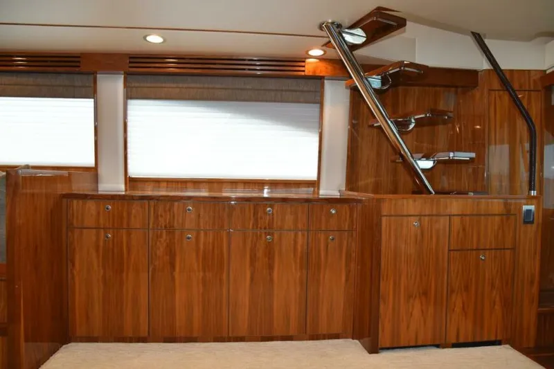 Slide: The Image of Luxurious wooden interior of 2017 Viking 80 Sky Bridge yacht with modern staircase. - 24