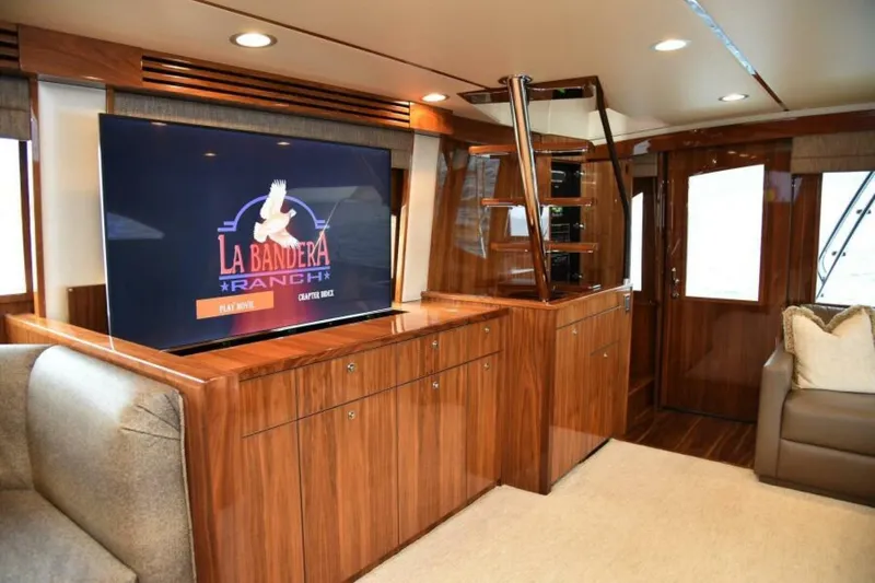 Slide: The Image of Luxurious interior of 2017 Viking 80 Sky Bridge yacht with wood finish and entertainment system. - 27