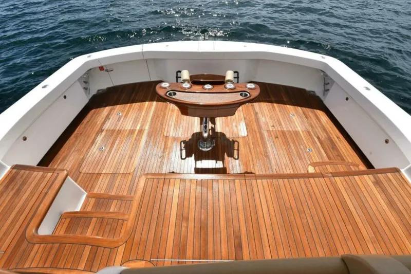 Slide: The Image of Luxurious teak deck of 2017 Viking 80 Sky Bridge yacht on open water. - 3