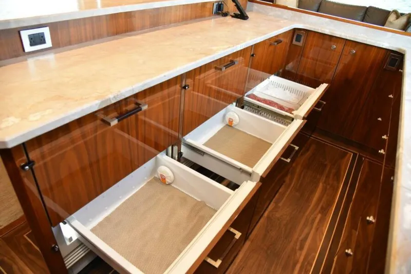 Slide: The Image of Luxurious kitchen drawers in 2017 Viking 80 Sky Bridge yacht, featuring elegant wood finish. - 31