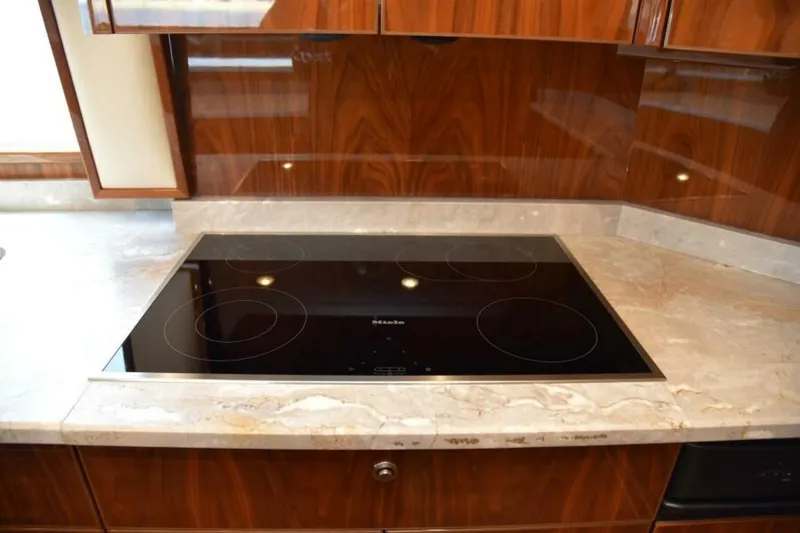 Slide: The Image of Modern kitchen with sleek cooktop on Viking 80 Sky Bridge yacht, 2017 model. - 32