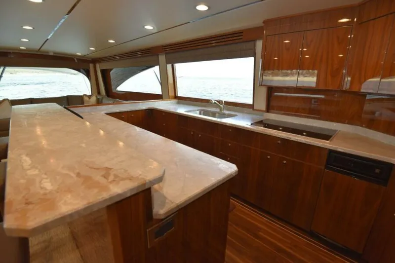 Slide: The Image of Luxurious kitchen interior of 2017 Viking 80 Sky Bridge yacht with elegant wood cabinetry. - 33