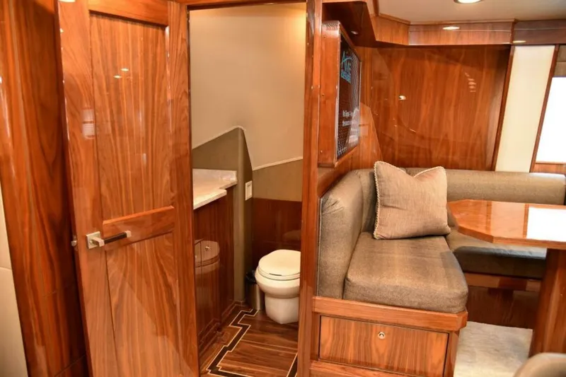 Slide: The Image of Luxurious interior of 2017 Viking 80 Sky Bridge yacht with wood finishes and cozy seating. - 34